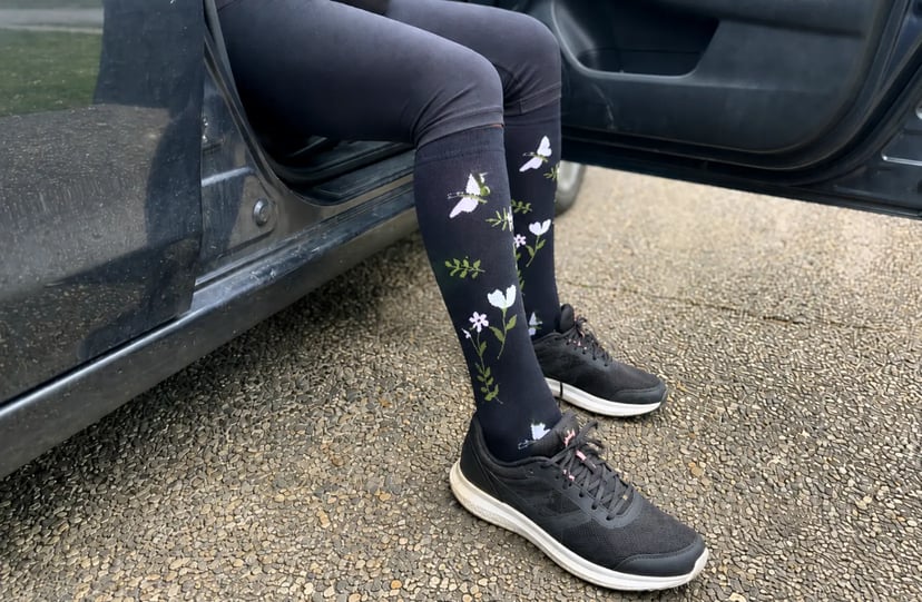 Pregnant woman walking while wearing floral Evirelle compression socks